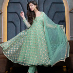 Green and gold-toned semi-stitched dress material