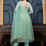 Green and gold-toned semi-stitched dress material